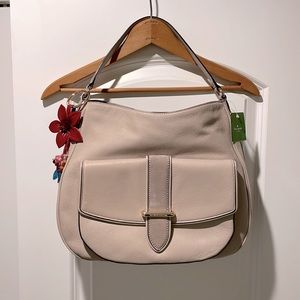 Tan medium sized shoulder bag with multiple pockets and original charm